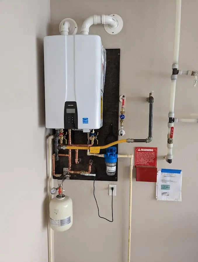 Professional plumber installing copper piping in a Angola home